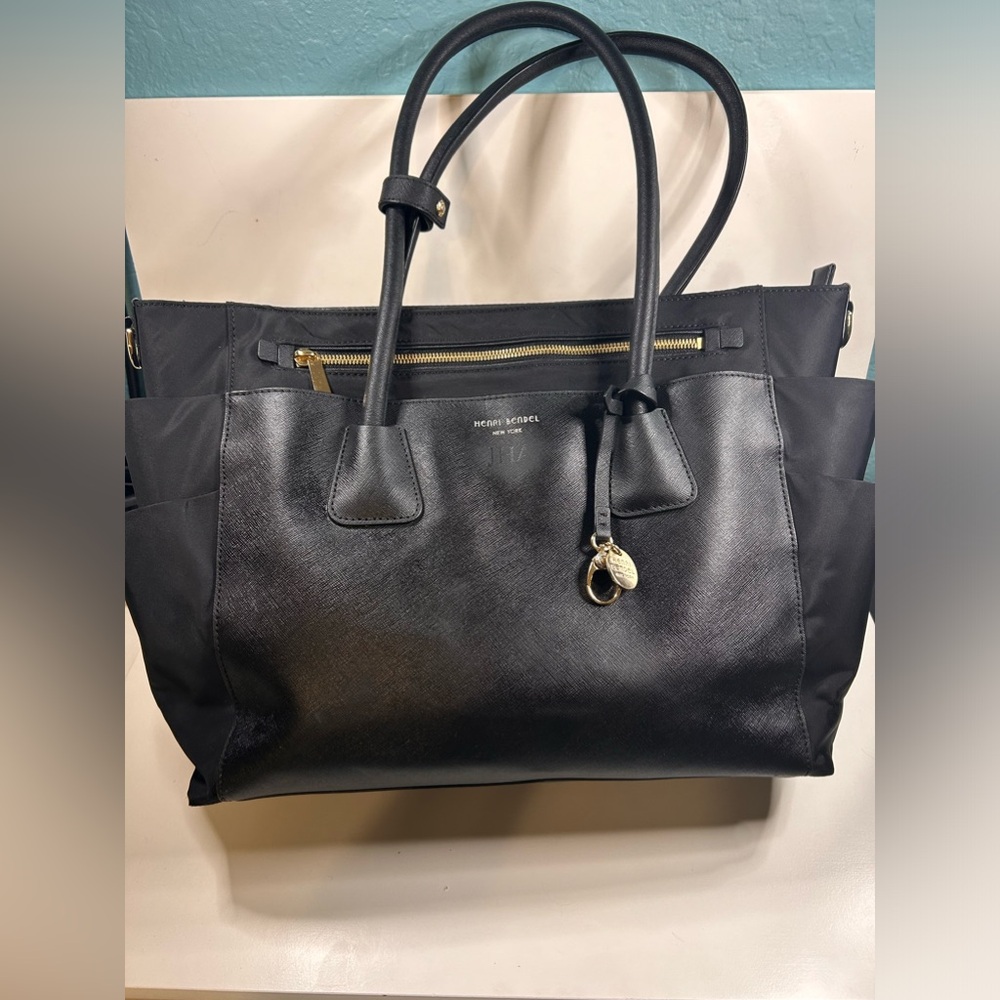 Henri Bendel black leather West 57th shoulder.  Purple lining, dustcover